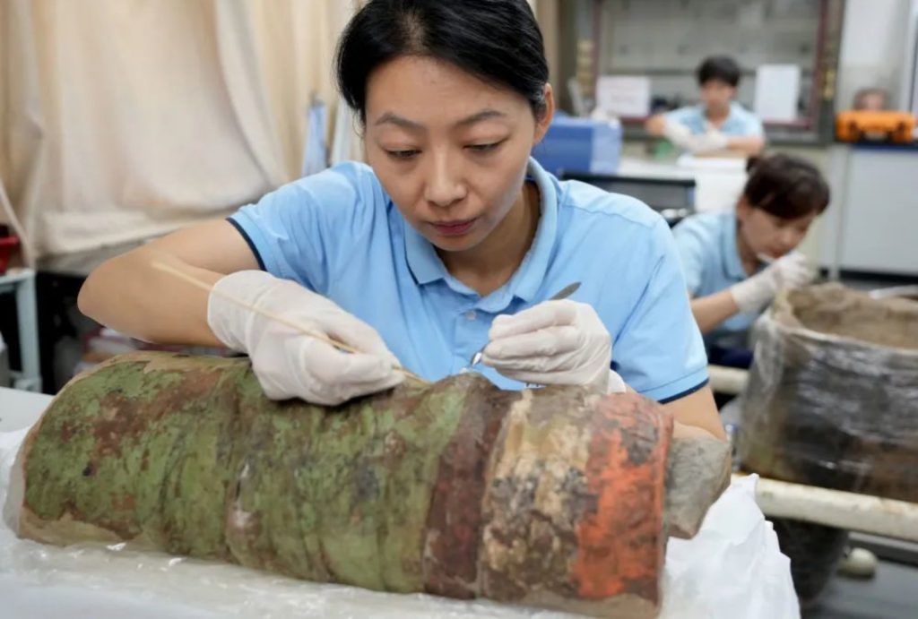 Staff are restoring painted terracotta warriors.